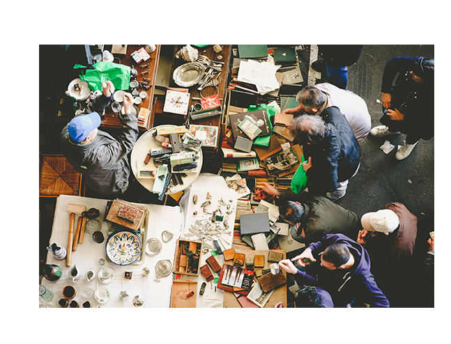 muchas personas trabajando con objetos diversos sobre una mesa